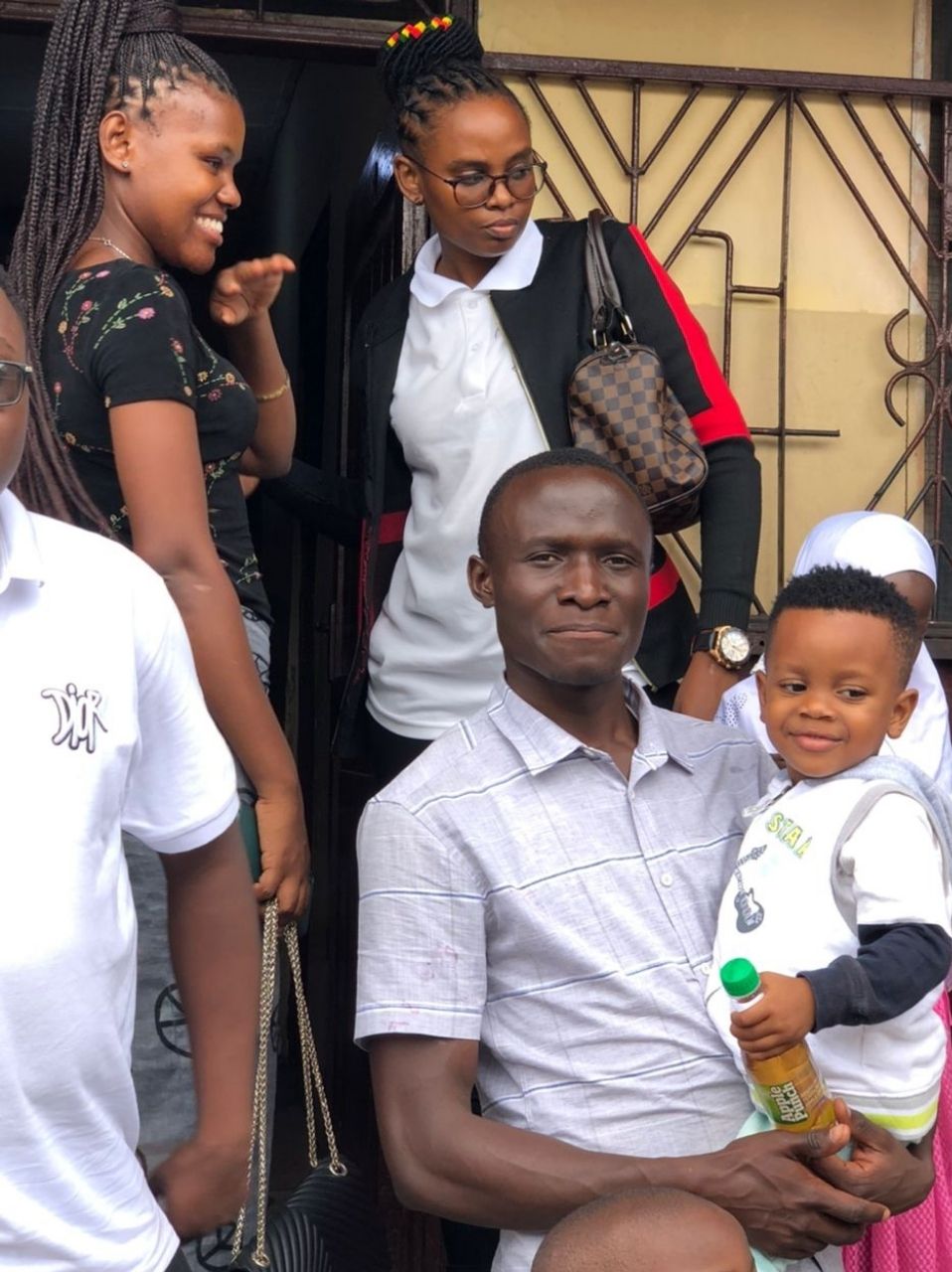 ESC member carrying a child during the Tandale orphanage visit