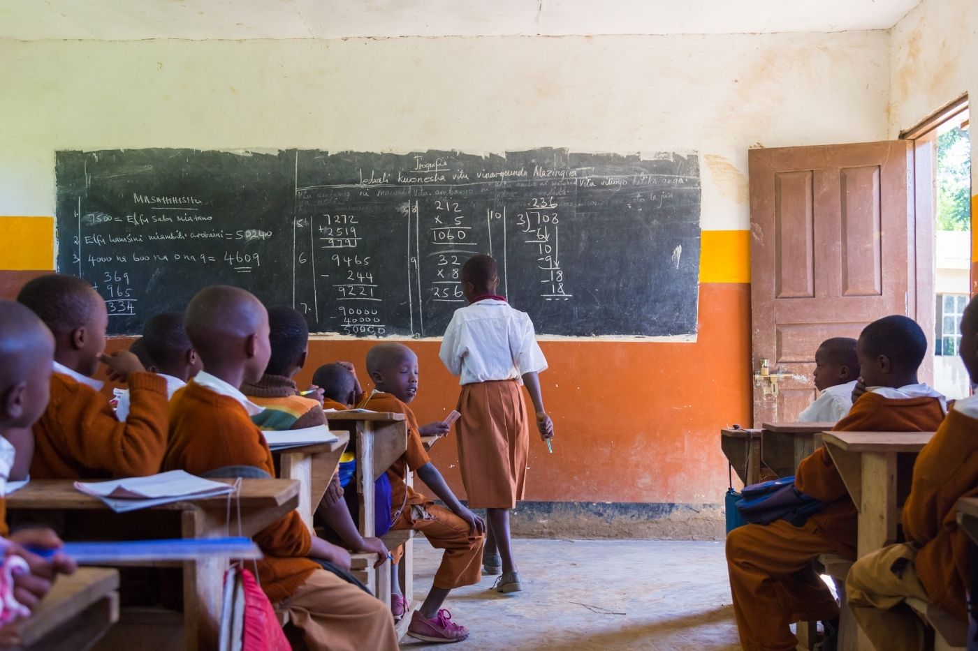 Students in a classroom setting with learning materials on desks