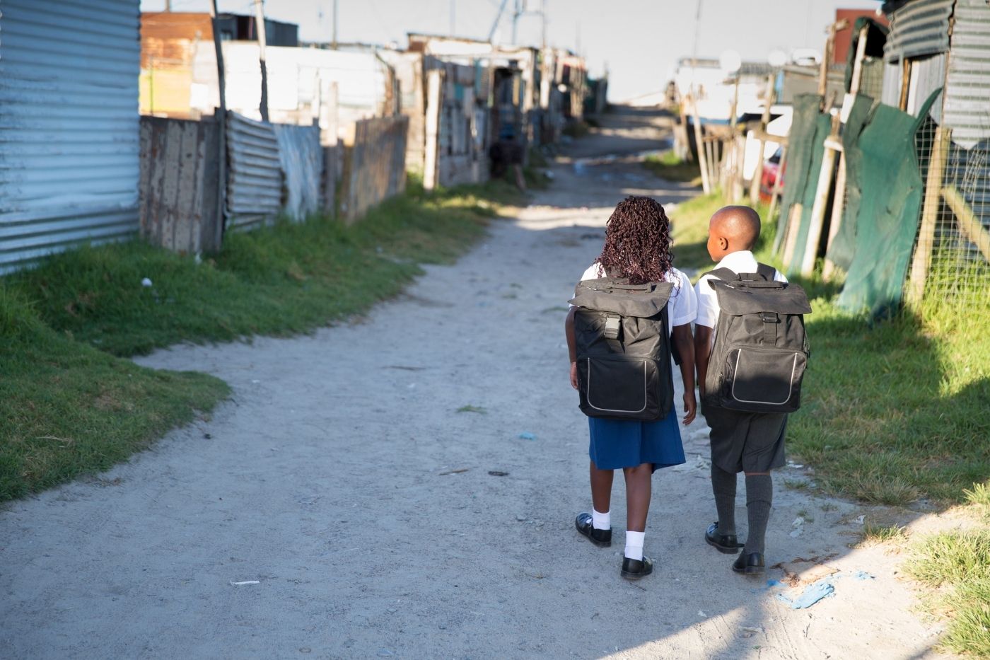 Students carrying backpacks and school supplies