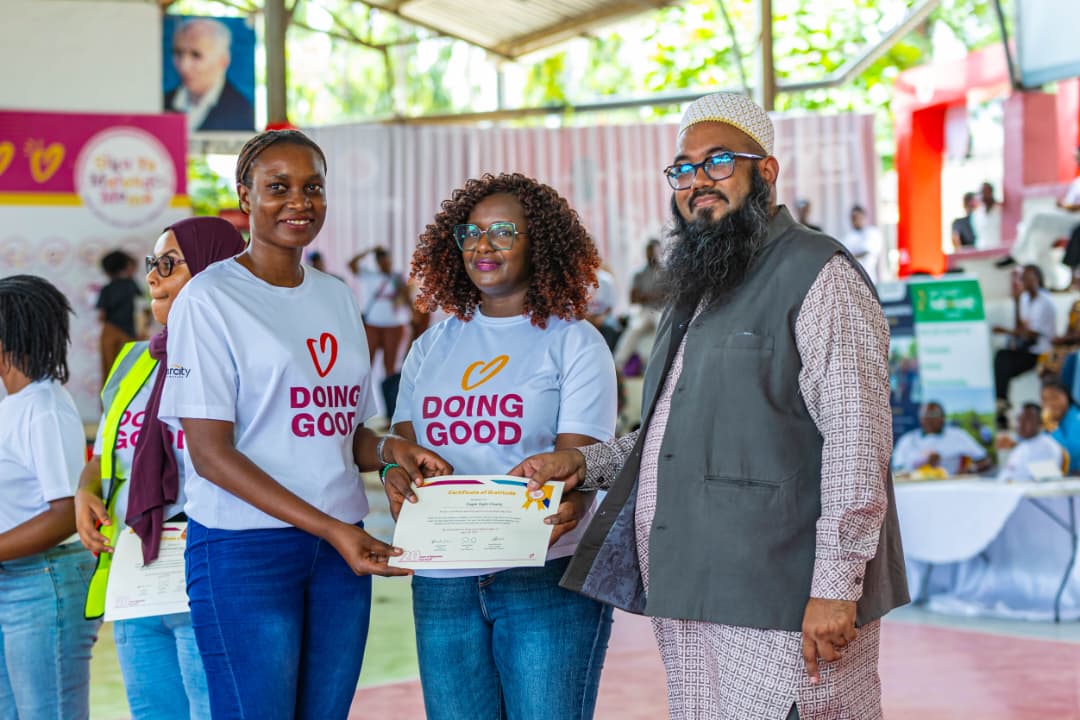 Celina Didas receiving a certificate on behalf of Eagle Sight Charity from the Guest of Honour during Good Deeds Day 2026
